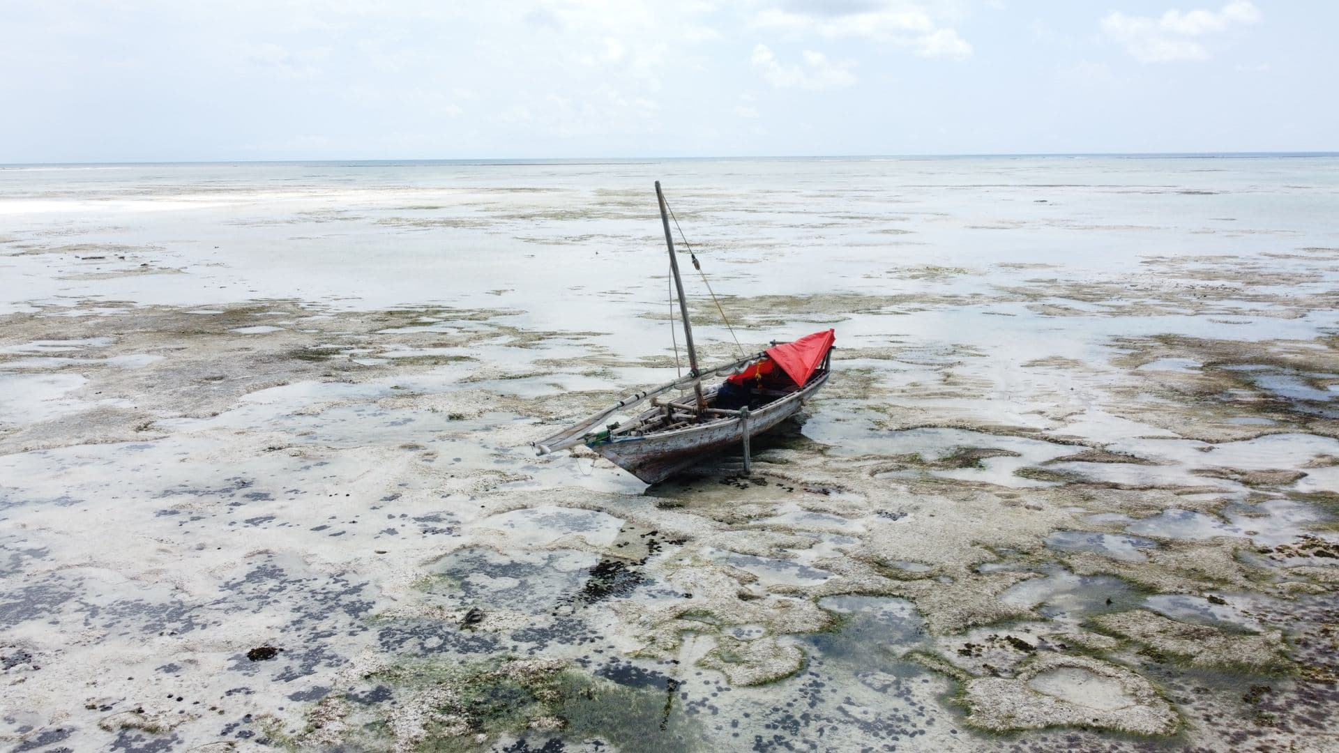 Fishing boat resting on the sand at low tide
